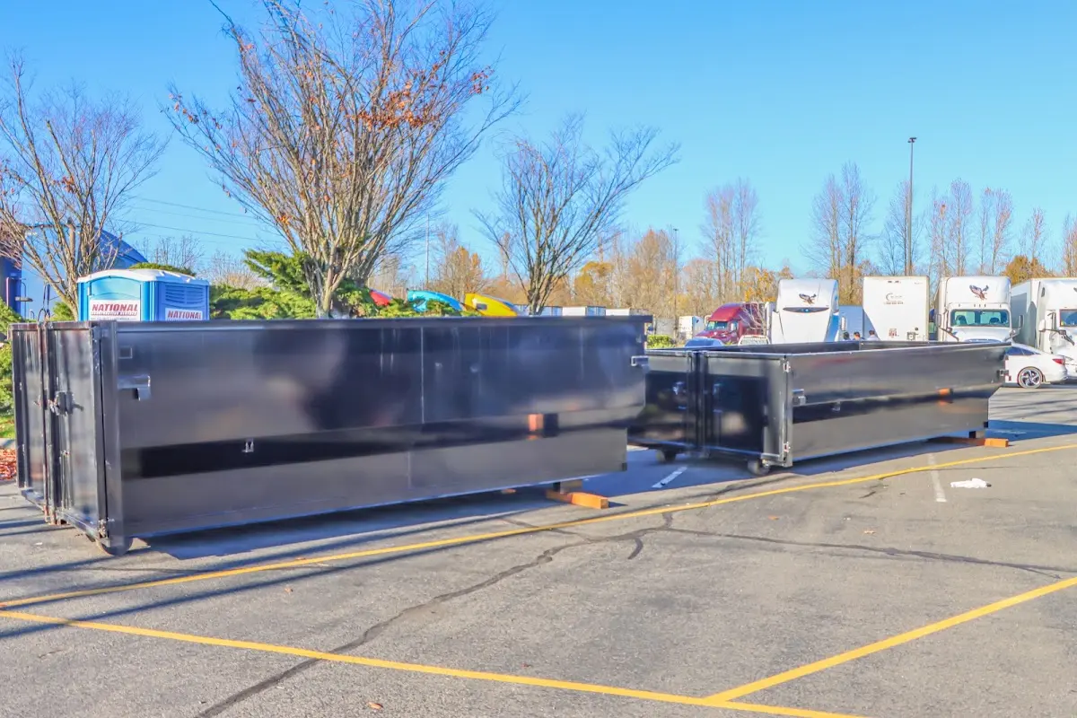 Professional dumpster rental service with roll-off container on residential driveway in St. Thomas
